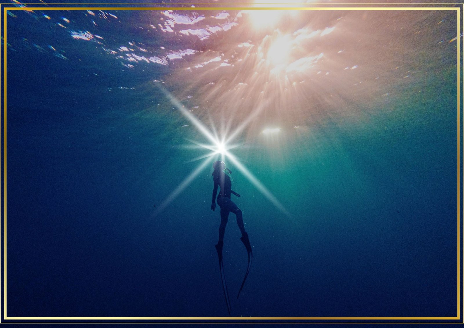A diver rising toward light under the sea